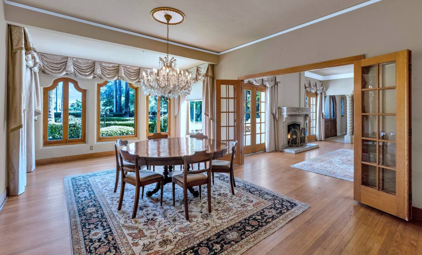 Formal dining room at 161 E Country Club Drive Phoenix with crystal chandelier and arched windows